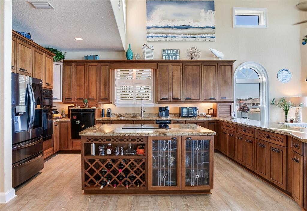 16480 Redington Drive Redington Beach, FL 33708 - Photo 14 of 93 a kitchen with stainless steel appliances granite countertop a stove a sink dishwasher and a refrigerator