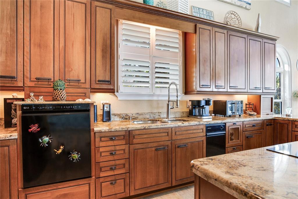 16480 Redington Drive Redington Beach, FL 33708 - Photo 15 of 93 a kitchen with a sink stove and cabinets