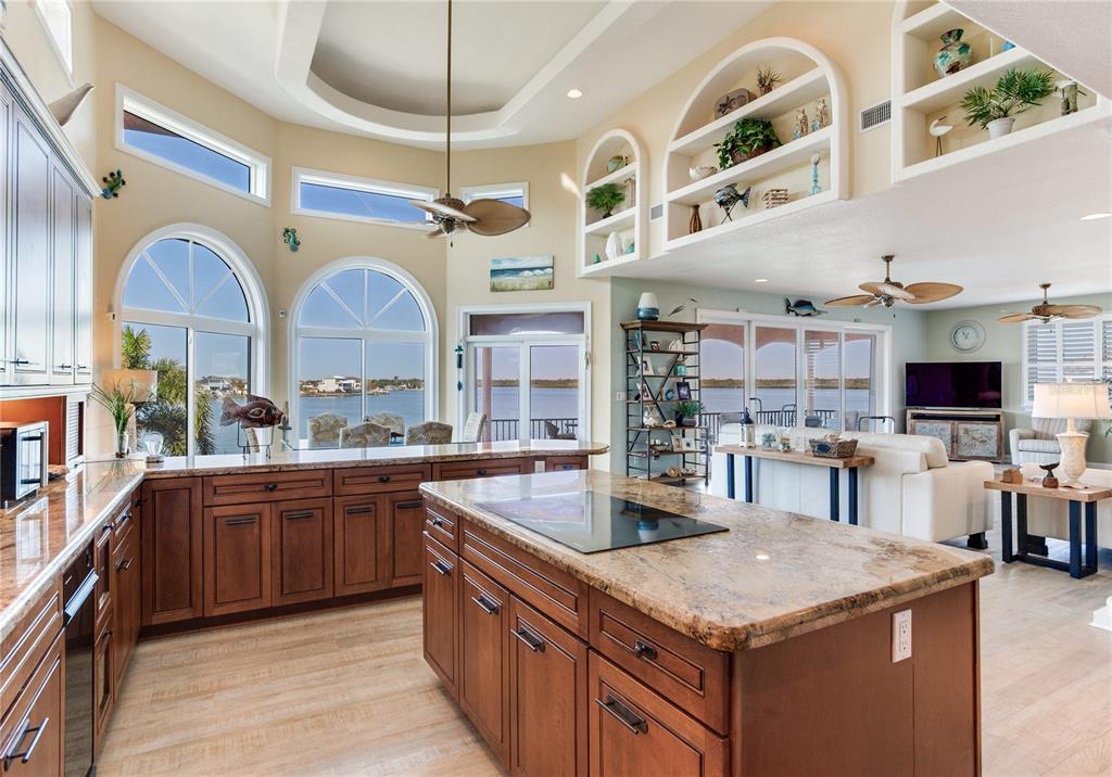 16480 Redington Drive Redington Beach, FL 33708 - Photo 16 of 93 a kitchen with stainless steel appliances granite countertop a sink and cabinets