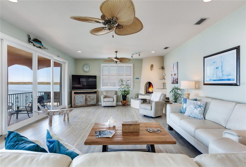 16480 Redington Drive Redington Beach, FL 33708 - Photo 20 of 93 a living room with fireplace furniture and a flat screen tv