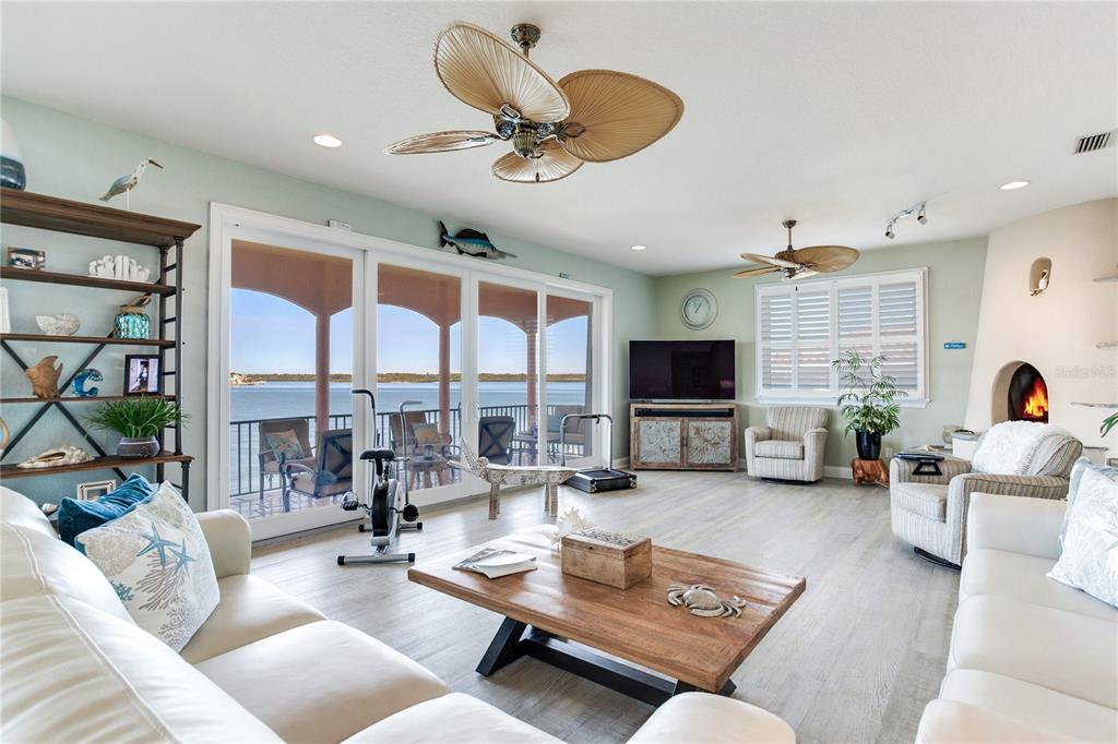 16480 Redington Drive Redington Beach, FL 33708 - Photo 21 of 93 a living room with furniture floor to ceiling window and a flat screen tv