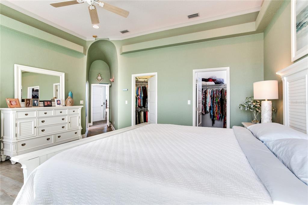 16480 Redington Drive Redington Beach, FL 33708 - Photo 30 of 93 a spacious bedroom with a bed and a mirror