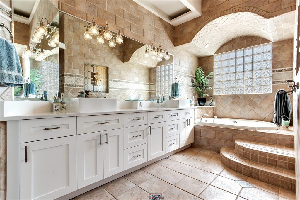 16480 Redington Drive Redington Beach, FL 33708 - Photo 35 of 93 a bathroom with a sink a vanity and a mirror