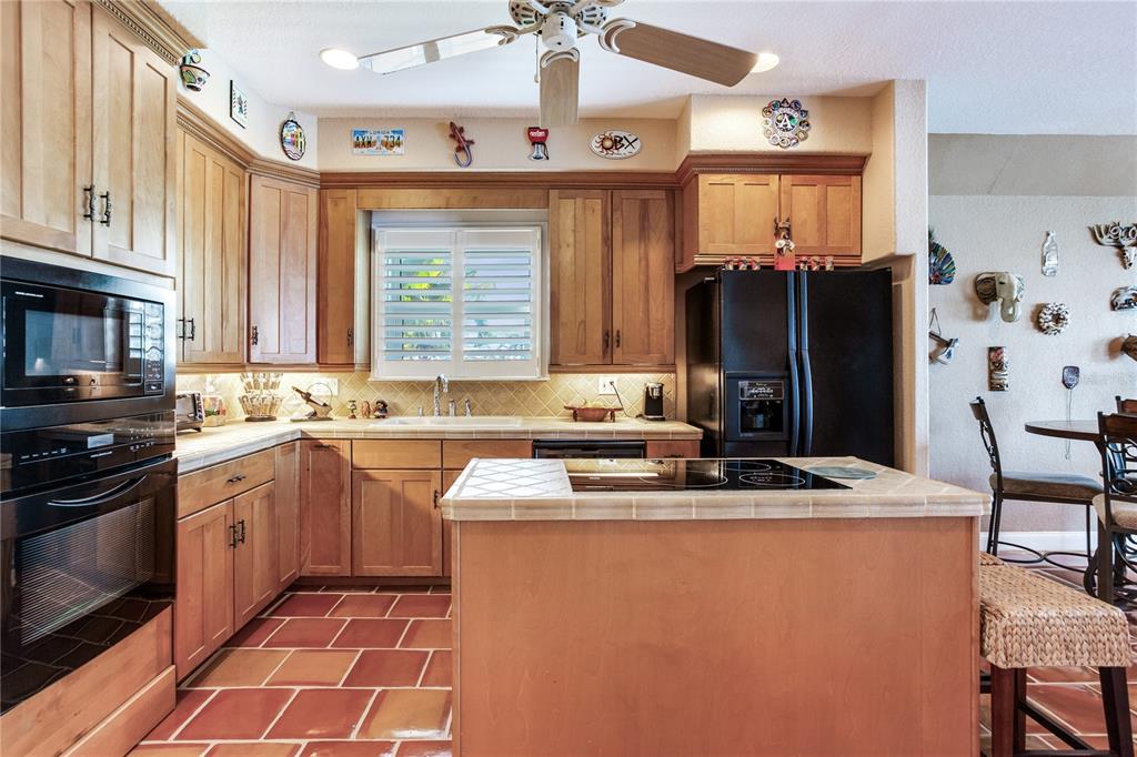 16480 Redington Drive Redington Beach, FL 33708 - Photo 45 of 93 a kitchen with stainless steel appliances granite countertop a sink stove and refrigerator