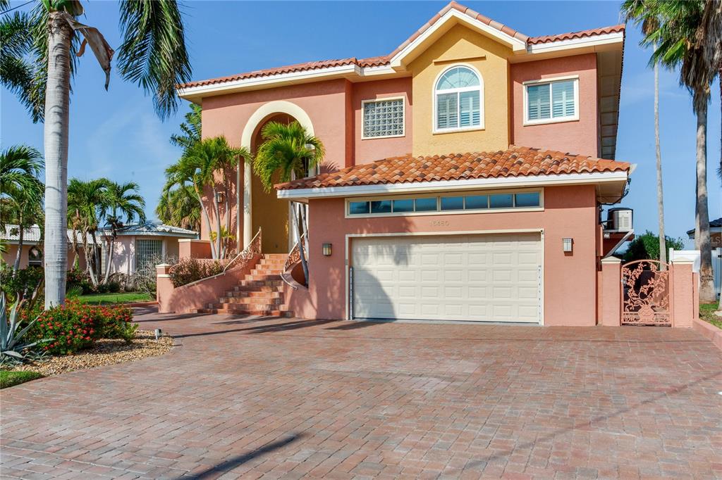16480 Redington Drive Redington Beach, FL 33708 - Photo 5 of 93 a front view of a house with a yard and garage