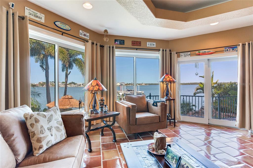 16480 Redington Drive Redington Beach, FL 33708 - Photo 54 of 93 a living room with furniture and a floor to ceiling window