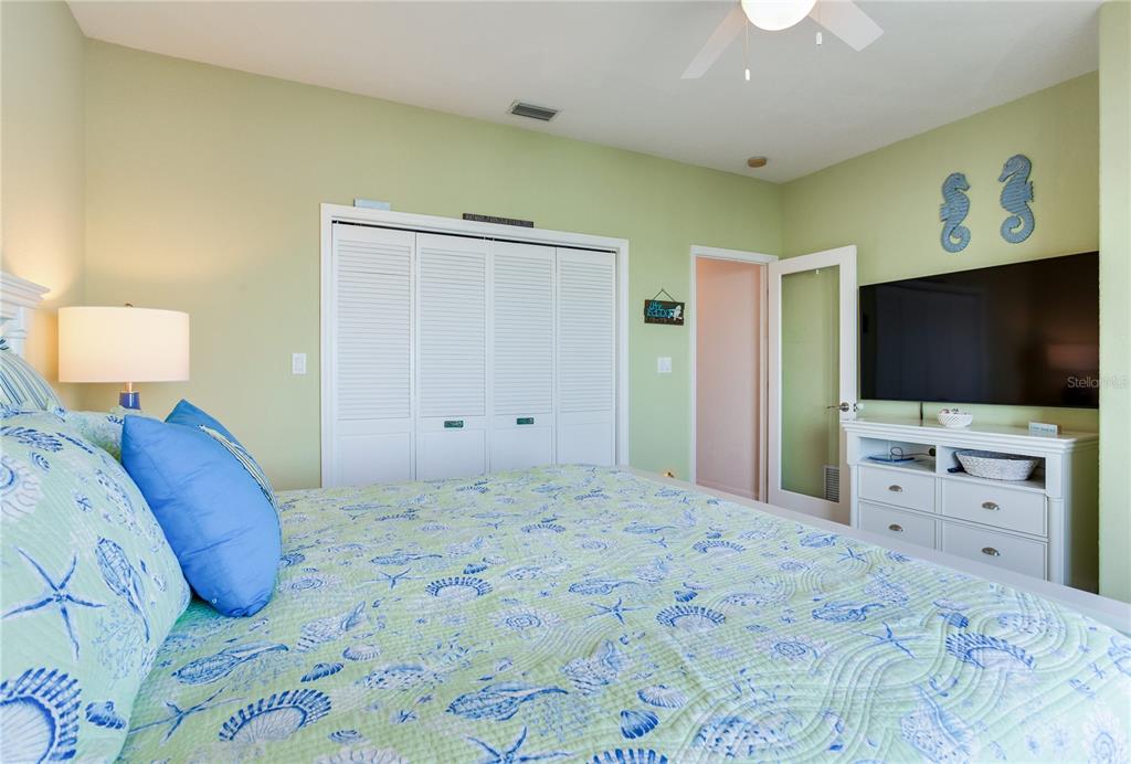 16480 Redington Drive Redington Beach, FL 33708 - Photo 64 of 93 a bedroom with a bed and a flat screen tv in it