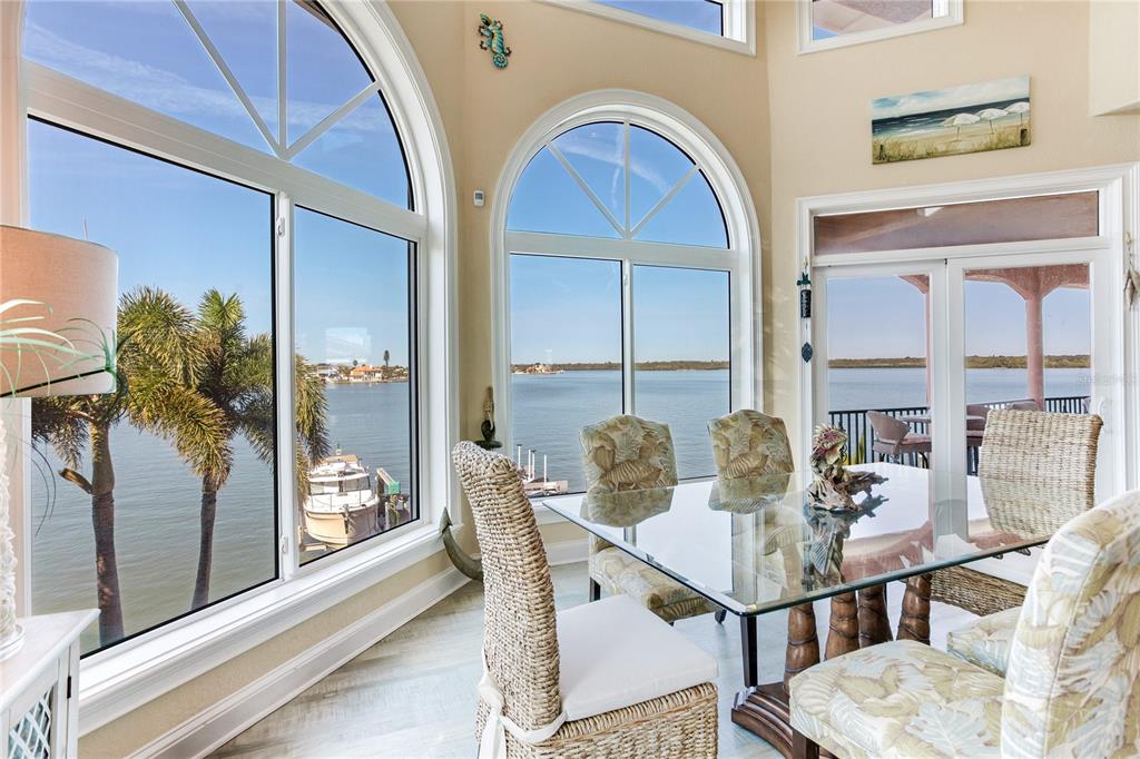 16480 Redington Drive Redington Beach, FL 33708 - Photo 7 of 93 a view of a dining room with furniture wooden floor and a floor to ceiling window