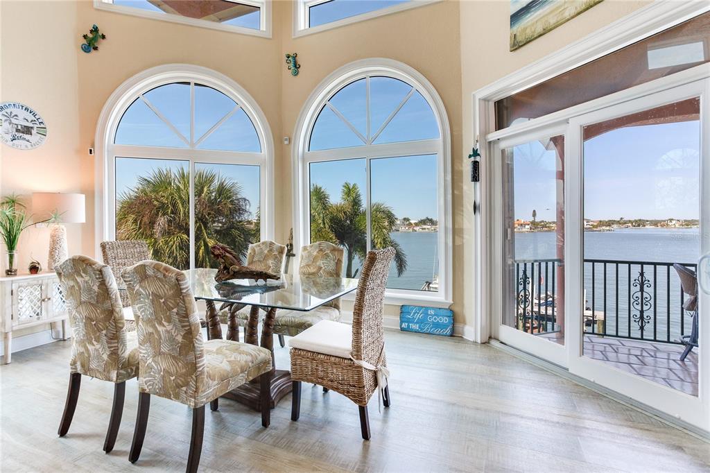 16480 Redington Drive Redington Beach, FL 33708 - Photo 10 of 93 a dining room with furniture large windows and a rug