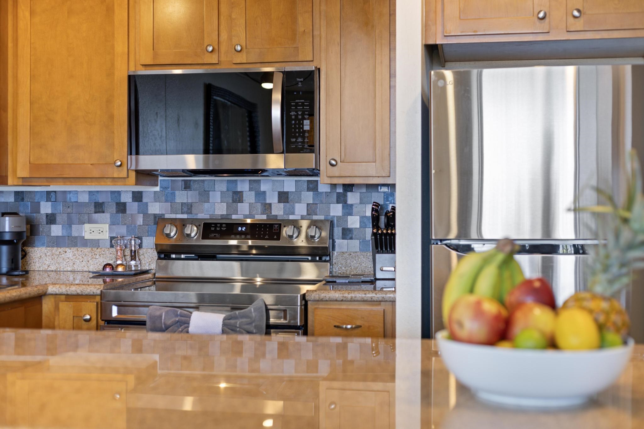 3445 Lower Honoapiilani Road, Unit 826 Lahaina, HI 96761 - Photo 11 of 26 a kitchen with a sink and a stove top oven
