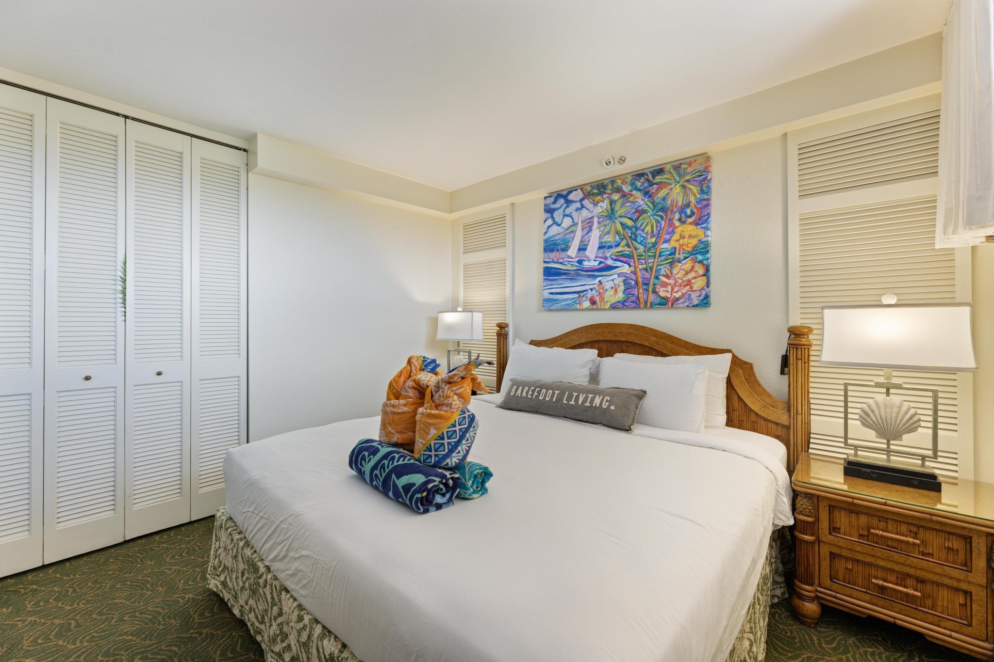 3445 Lower Honoapiilani Road, Unit 826 Lahaina, HI 96761 - Photo 13 of 26 a bedroom with a bed and wooden floor
