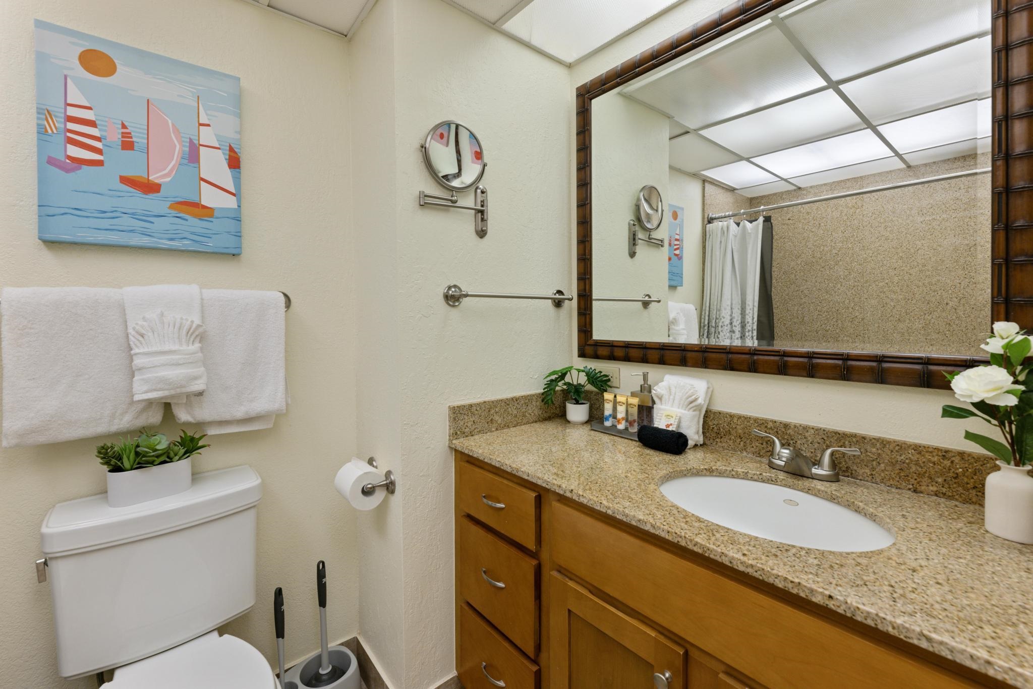 3445 Lower Honoapiilani Road, Unit 826 Lahaina, HI 96761 - Photo 14 of 26 a bathroom with a granite countertop sink mirror vanity and toilet