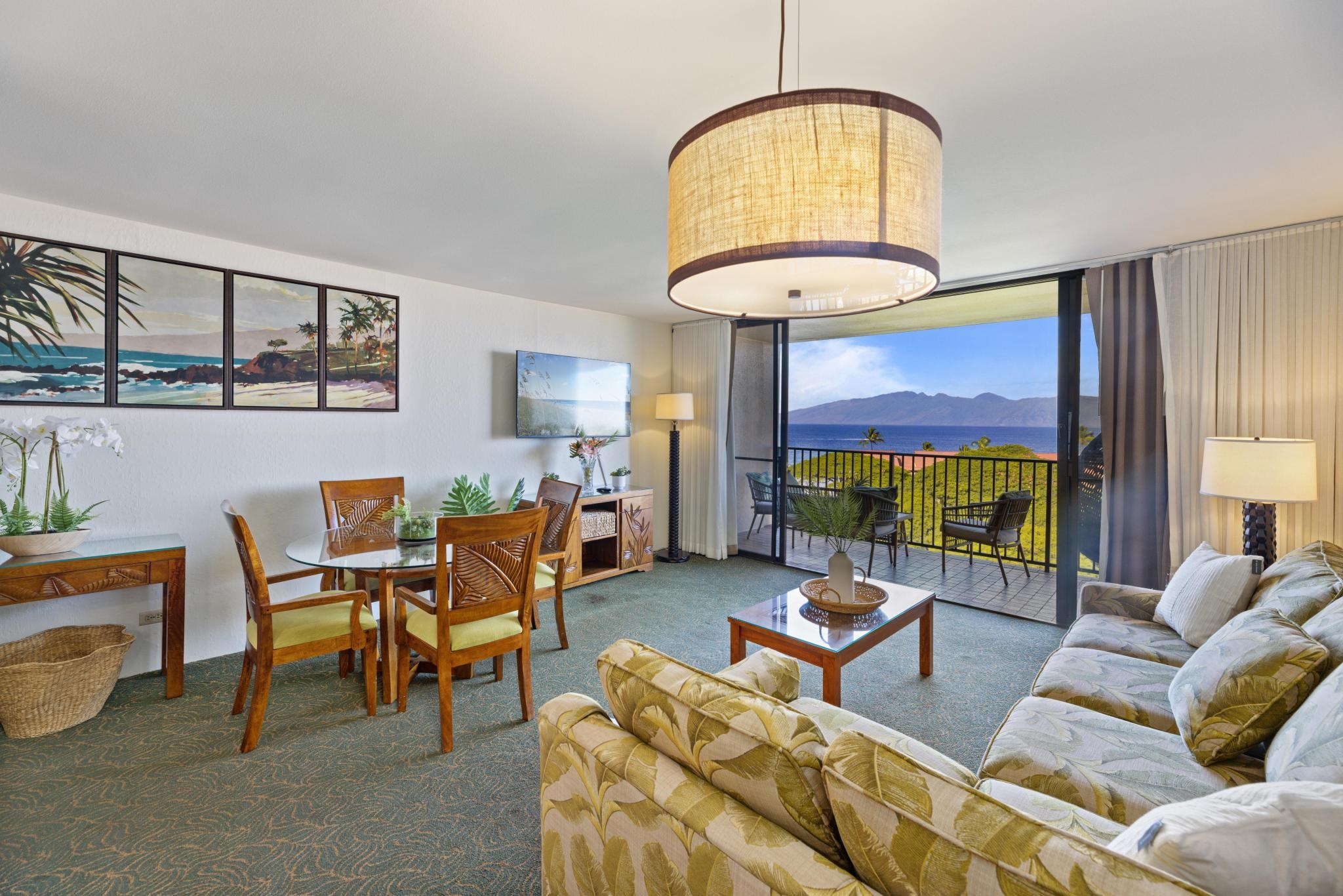3445 Lower Honoapiilani Road, Unit 826 Lahaina, HI 96761 - Photo 4 of 26 a living room with furniture a fireplace and a floor to ceiling window