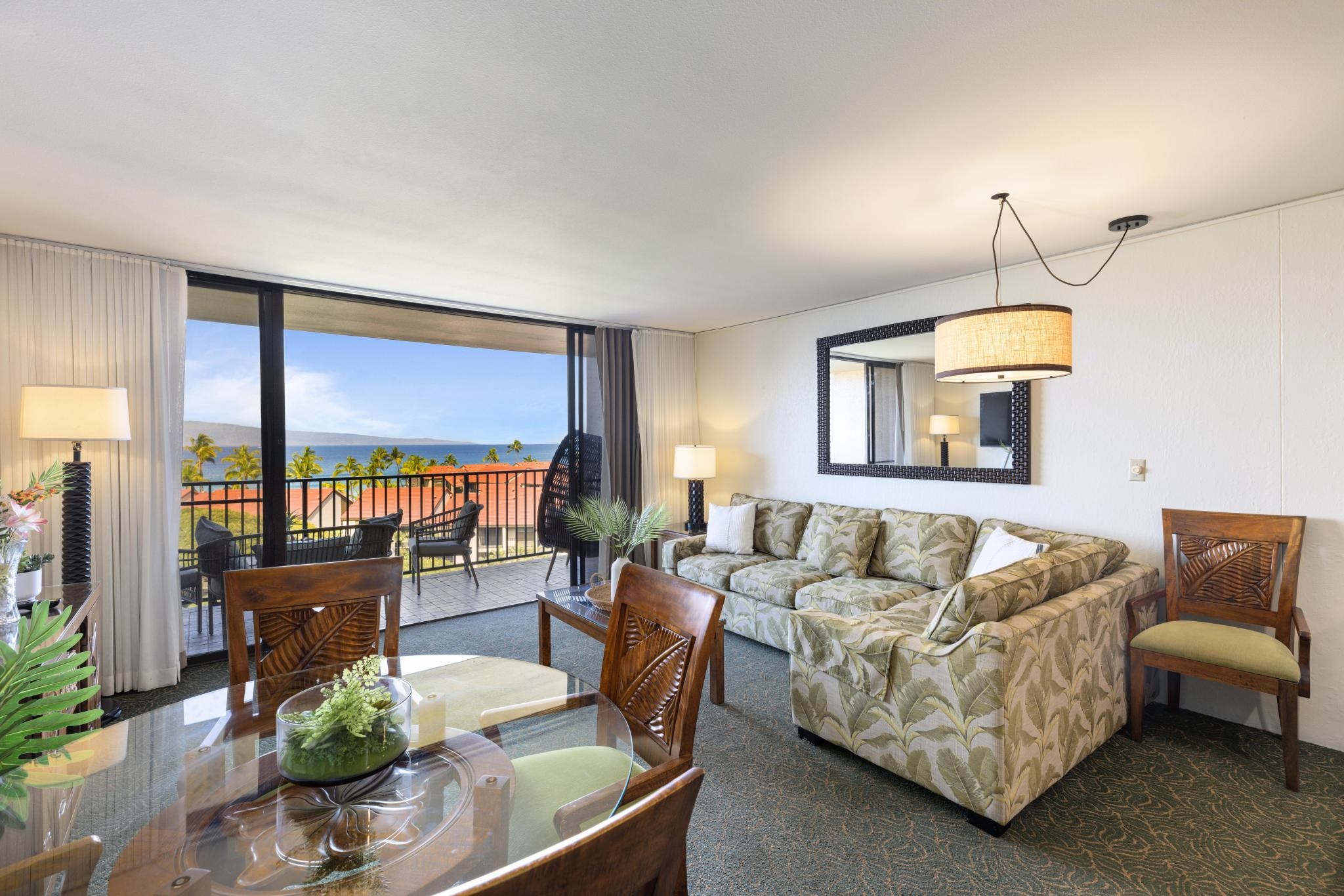 3445 Lower Honoapiilani Road, Unit 826 Lahaina, HI 96761 - Photo 5 of 26 a living room with furniture fireplace and a large window