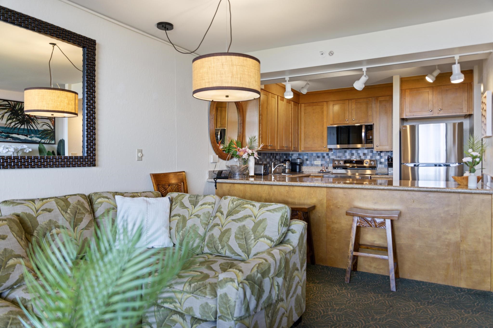 3445 Lower Honoapiilani Road, Unit 826 Lahaina, HI 96761 - Photo 7 of 26 a living room filled with furniture and a chandelier