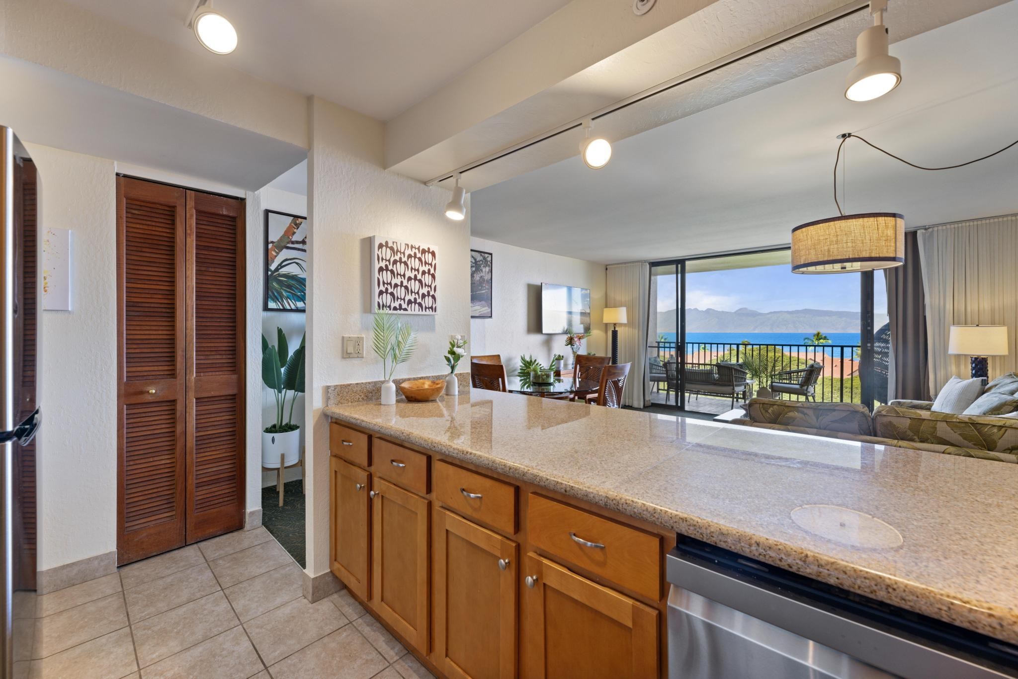 3445 Lower Honoapiilani Road, Unit 826 Lahaina, HI 96761 - Photo 8 of 26 a kitchen with stainless steel appliances a sink counter space cabinets and a large window