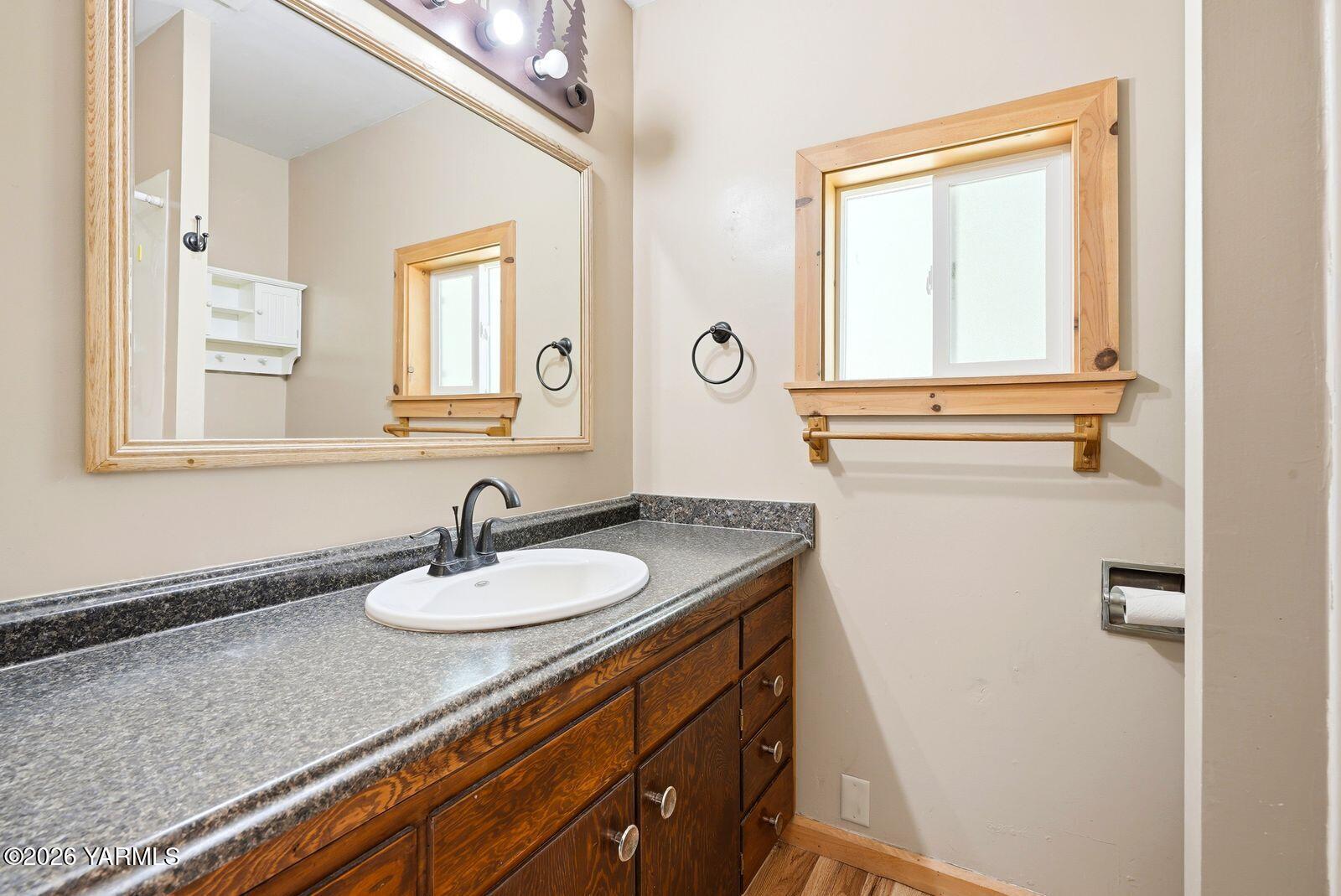 3780 Nile Road Naches, WA 98937 - Photo 17 of 43 a bathroom with a granite countertop sink a mirror and a window