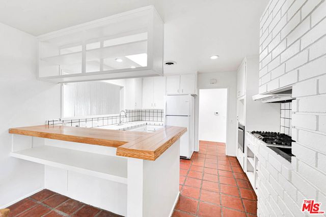 a spacious bedroom with a bed and a large window