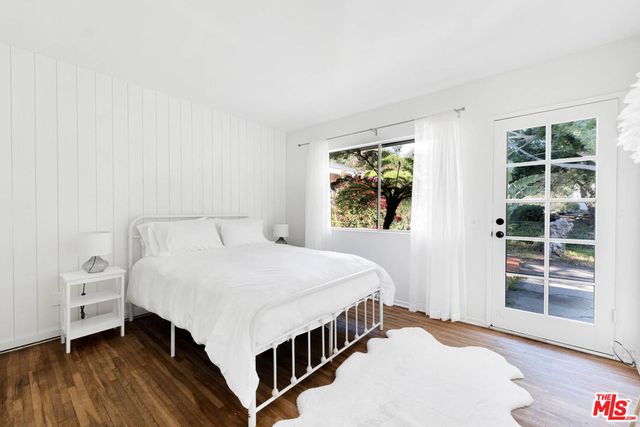 a bathroom with a double vanity sink a toilet a mirror and shower