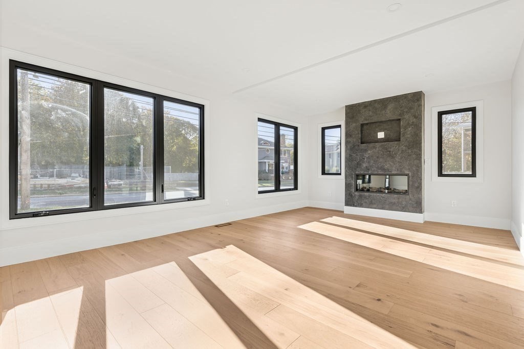 265-267 River Street, Unit 267 Newton, MA 02465 - Photo 2 of 22 a view of an empty room with wooden floor and a window
