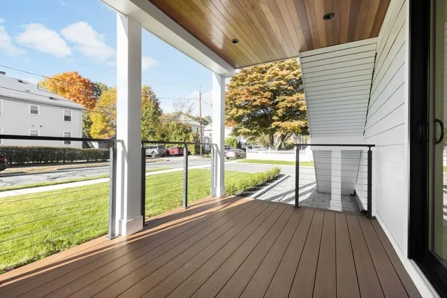 a view of a balcony with wooden floor