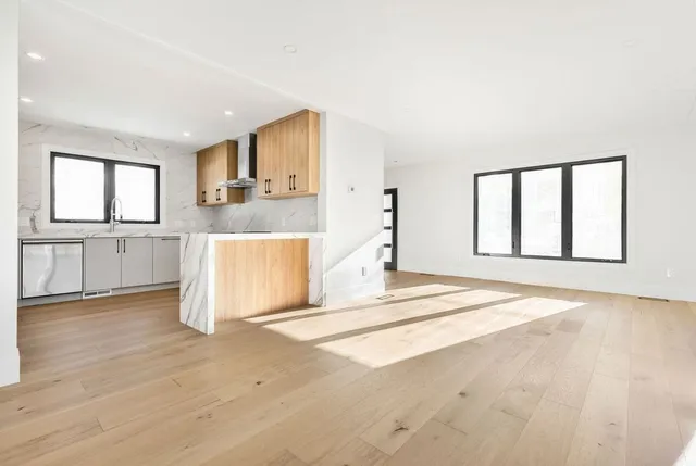 a view of a kitchen with wooden floor and a sink