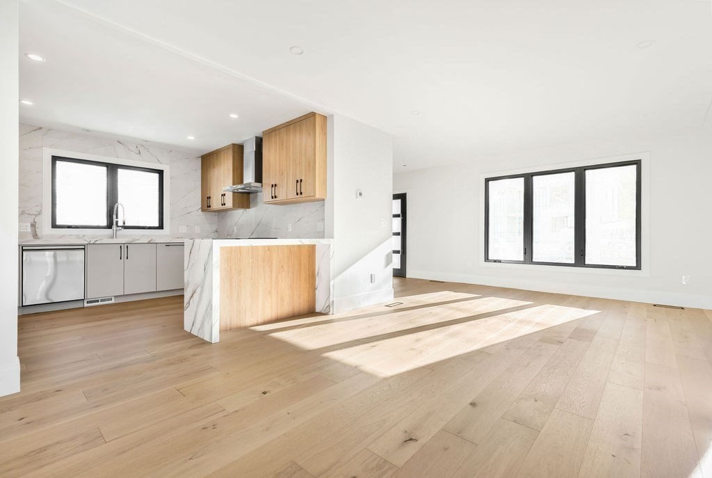 265-267 River Street, Unit 267 Newton, MA 02465 - Photo 3 of 22 a view of a kitchen with wooden floor and a sink