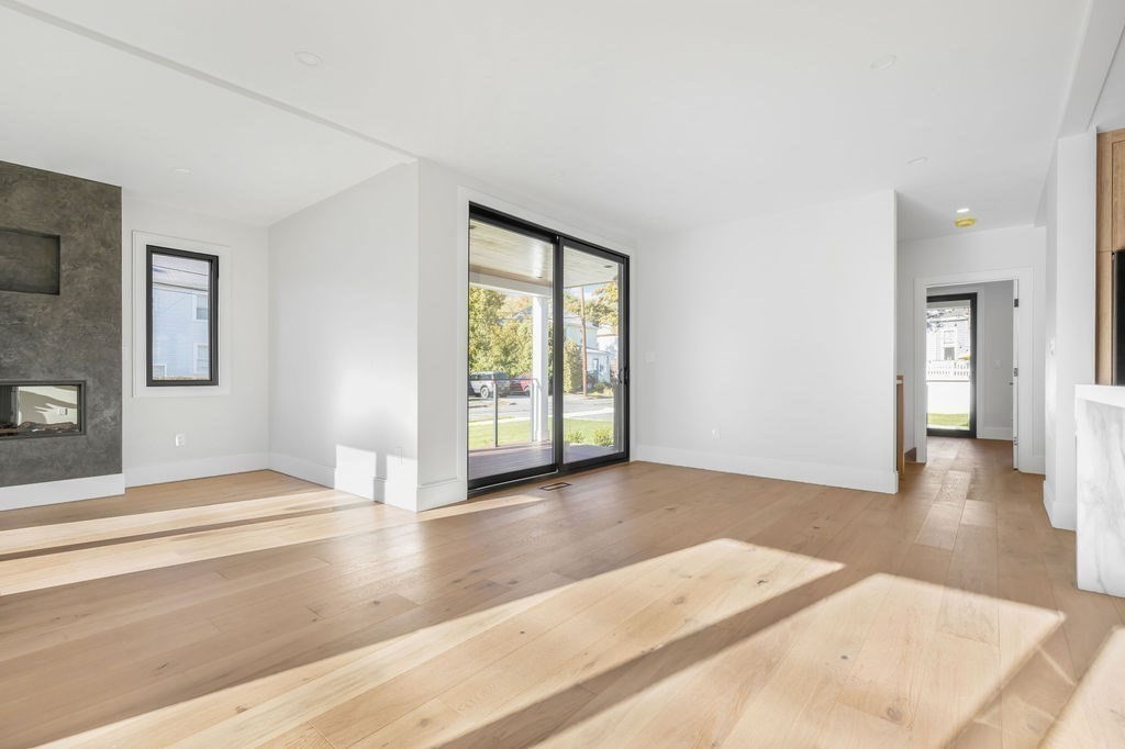 265-267 River Street, Unit 267 Newton, MA 02465 - Photo 4 of 22 a view of a room with wooden floor and window