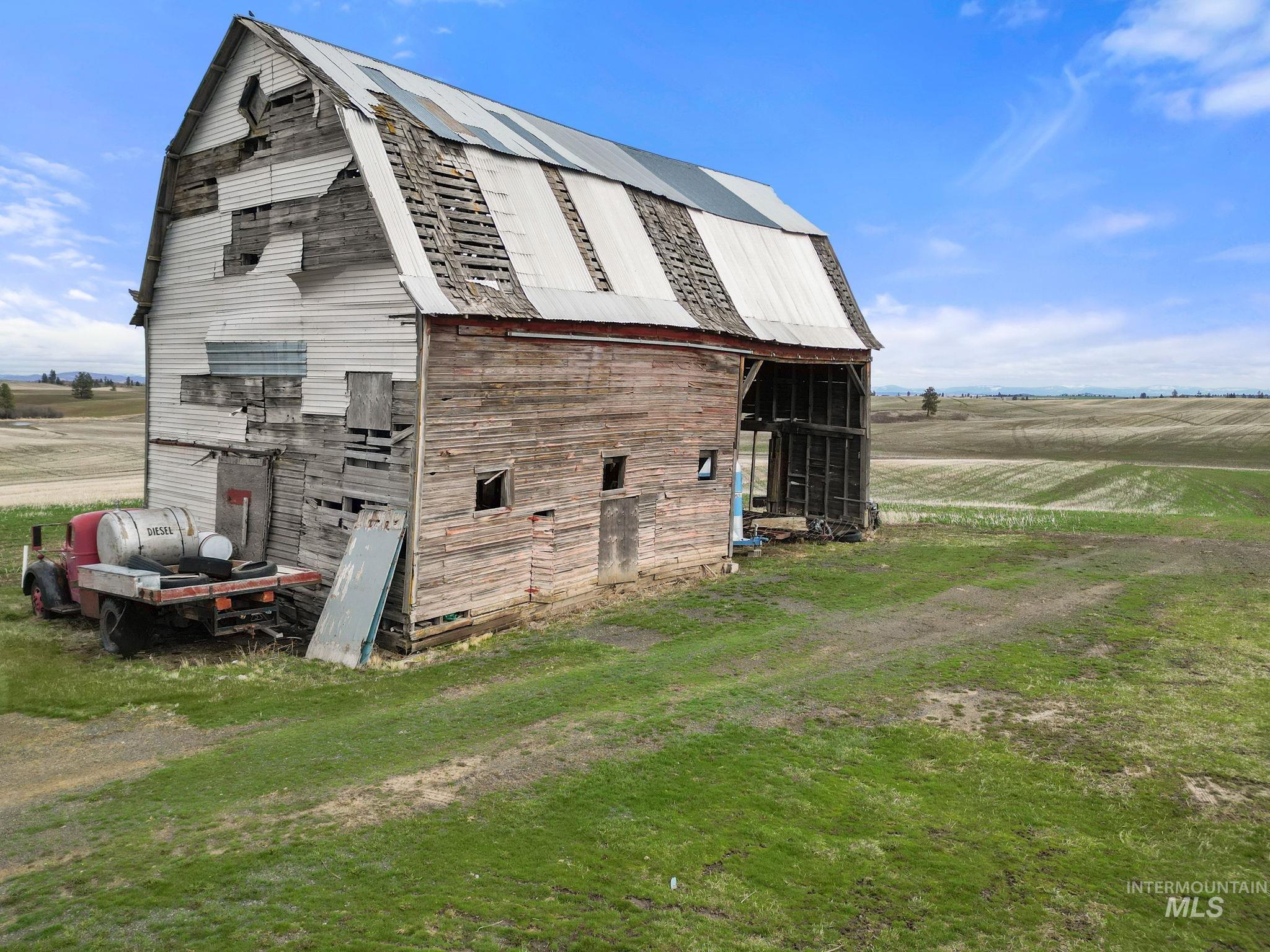2326 Reubens Road Reubens, ID 83548 - Photo 24 of 34 View of barn featuring a rural view, a sunroom, and a yard