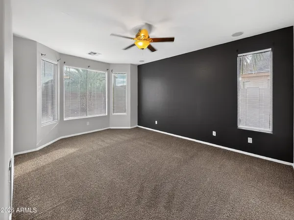 an empty room with windows and closet