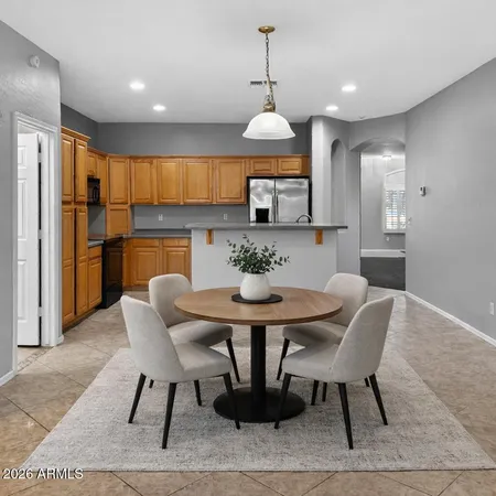 a kitchen with a refrigerator sink and cabinets