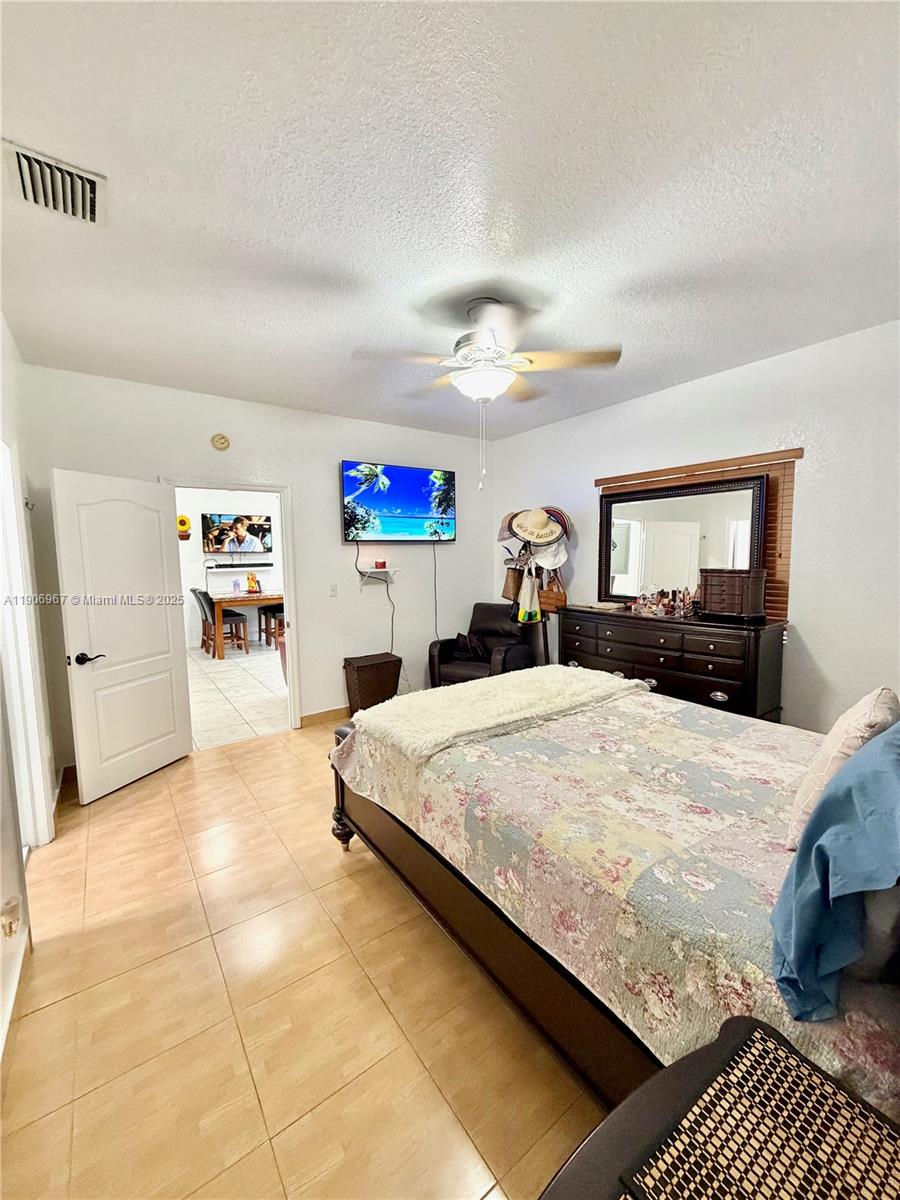 13778 Southwest 170th Lane Miami, FL 33177 - Photo 11 of 23 a bed room with a bed and a chair