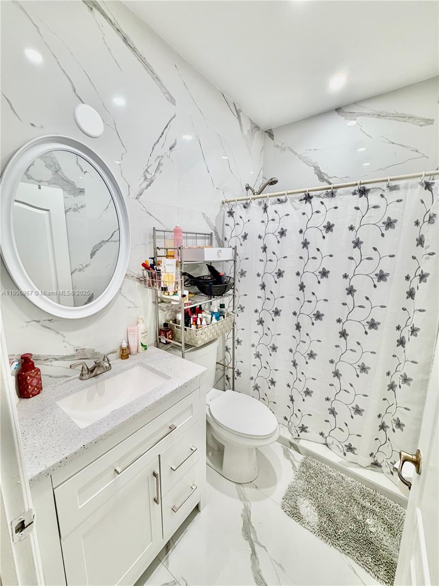 13778 Southwest 170th Lane Miami, FL 33177 - Photo 12 of 23 a bathroom with a sink toilet mirror and vanity