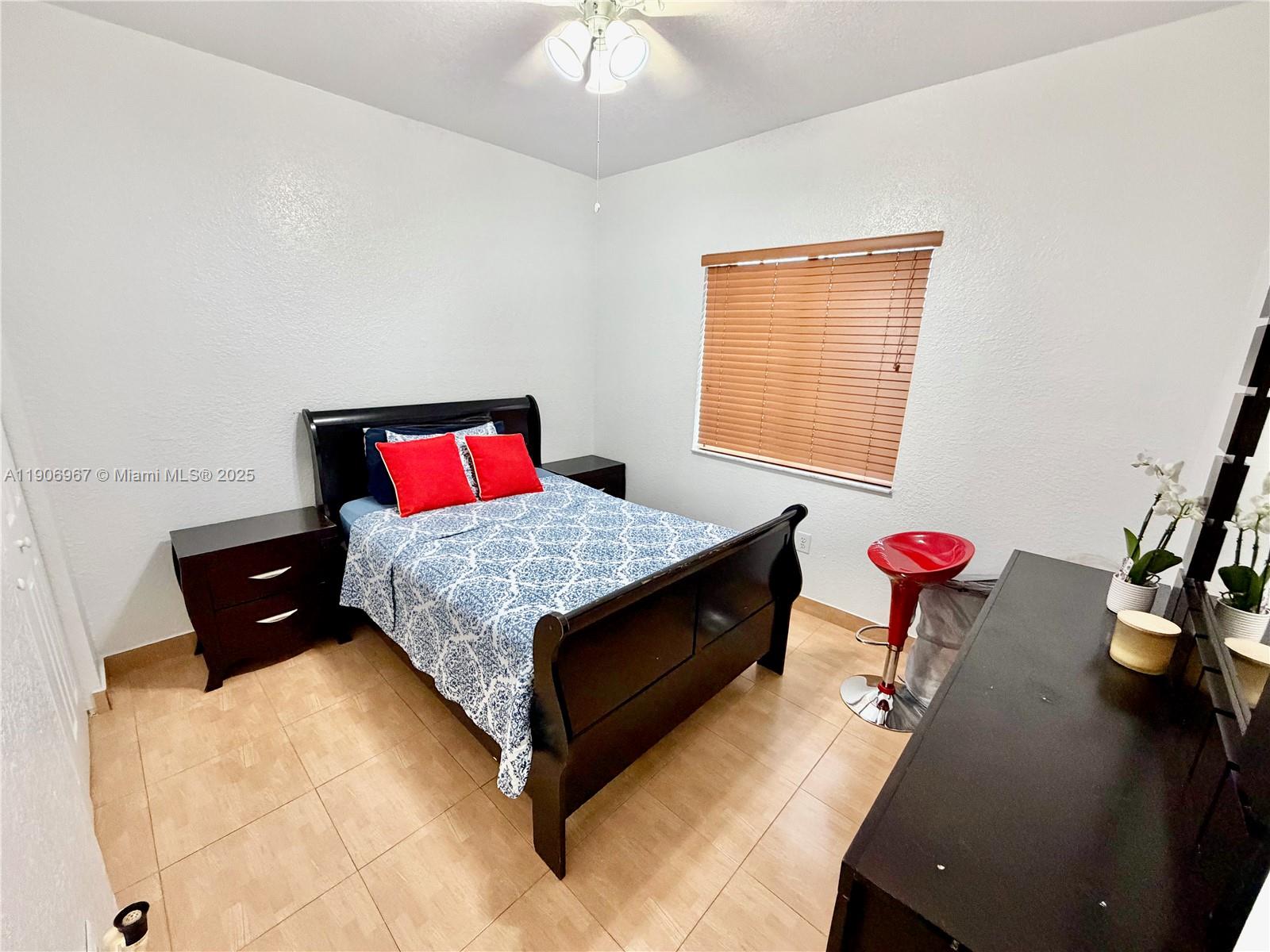 13778 Southwest 170th Lane Miami, FL 33177 - Photo 13 of 23 a bedroom with a bed and a dresser