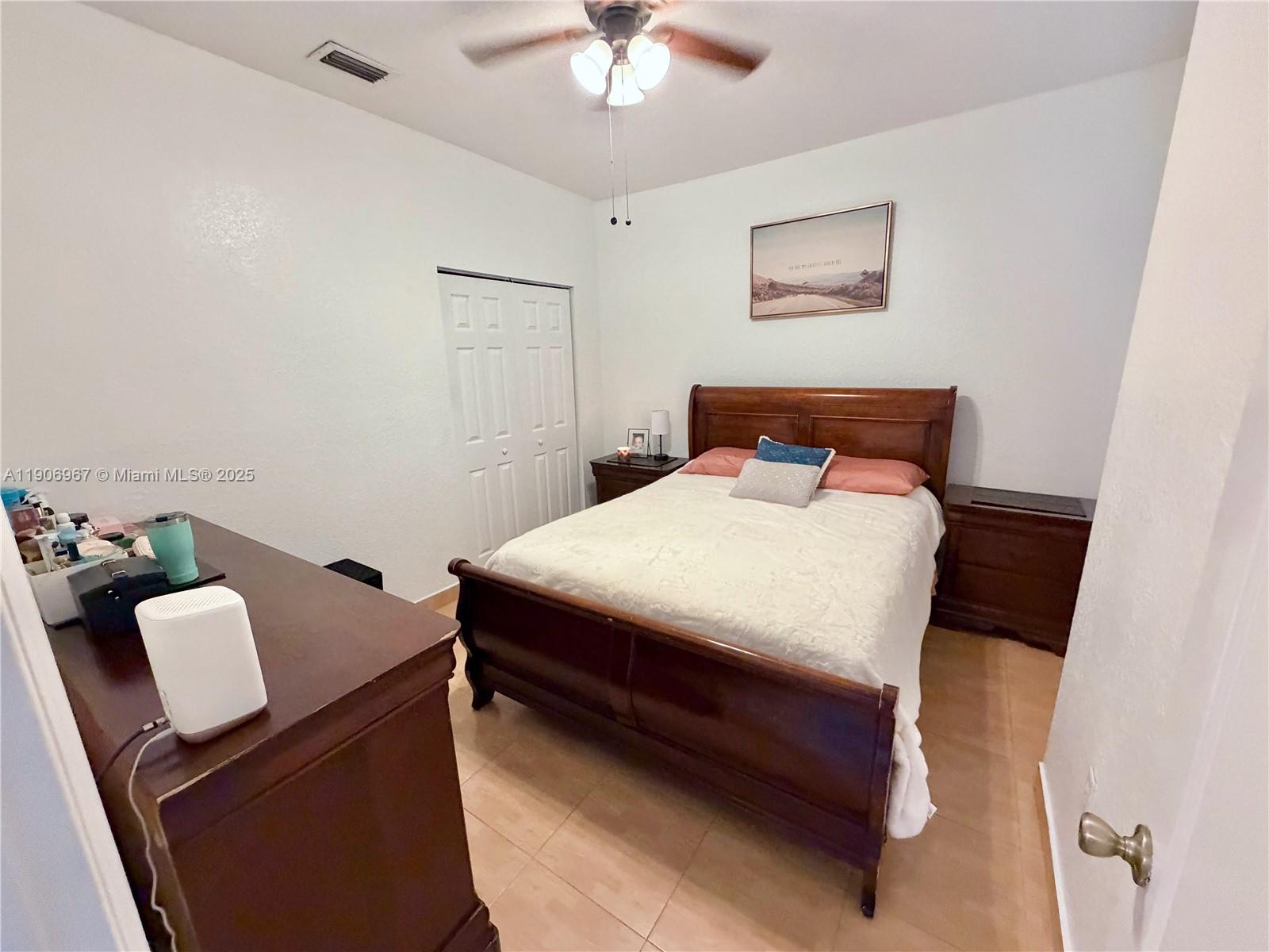 13778 Southwest 170th Lane Miami, FL 33177 - Photo 15 of 23 a bedroom with a bed and a chandelier