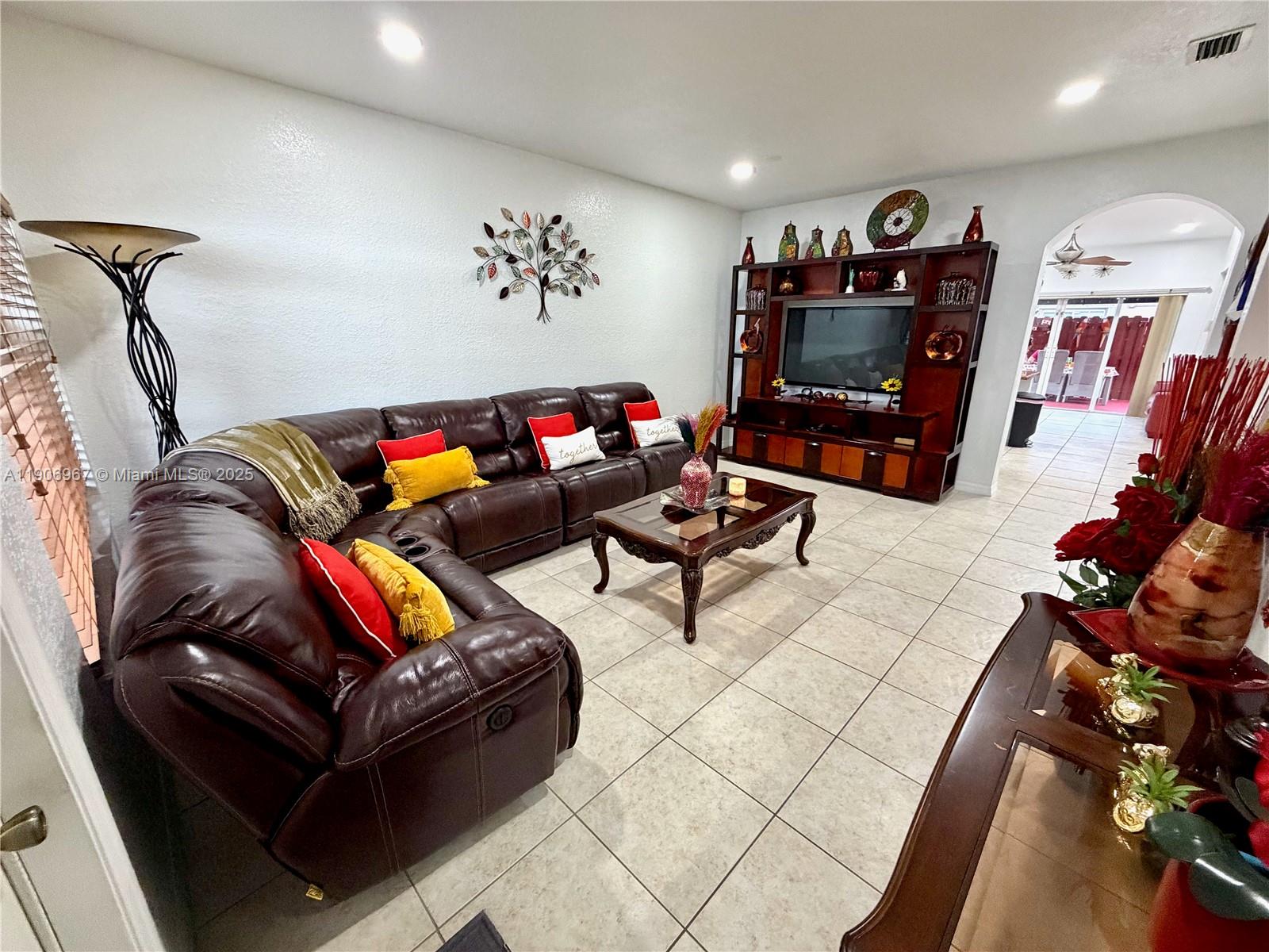13778 Southwest 170th Lane Miami, FL 33177 - Photo 2 of 23 a living room with furniture and a flat screen tv
