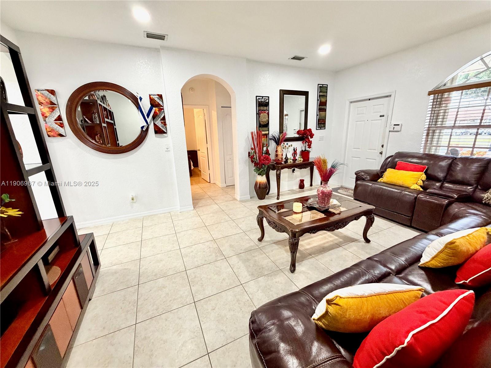 13778 Southwest 170th Lane Miami, FL 33177 - Photo 3 of 23 a living room with furniture and a mirror