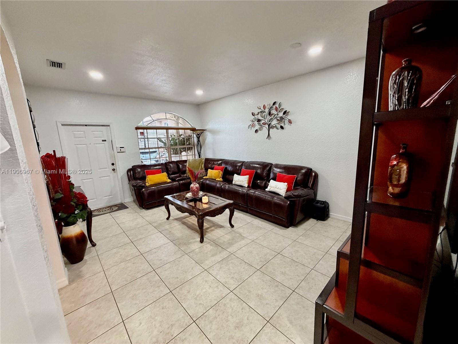 13778 Southwest 170th Lane Miami, FL 33177 - Photo 4 of 23 a living room with furniture and a flat screen tv