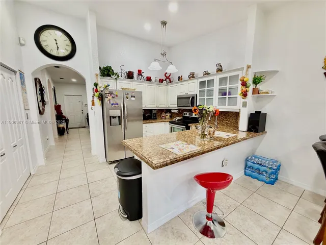 a kitchen with a sink a stove and cabinets