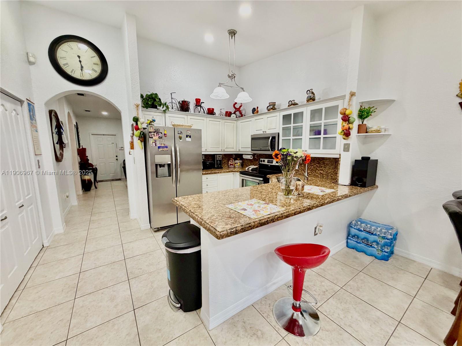 13778 Southwest 170th Lane Miami, FL 33177 - Photo 5 of 23 a kitchen with a sink a stove and cabinets
