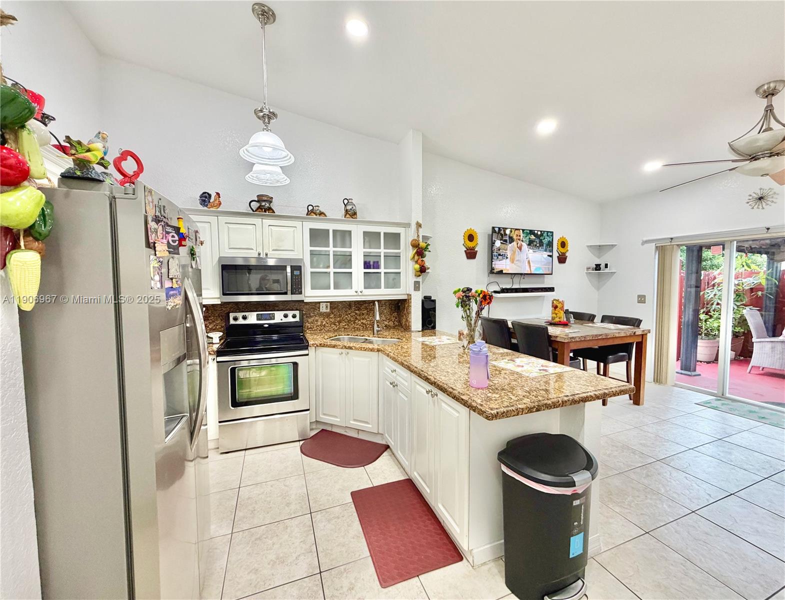 13778 Southwest 170th Lane Miami, FL 33177 - Photo 6 of 23 a kitchen with a refrigerator and a stove top oven