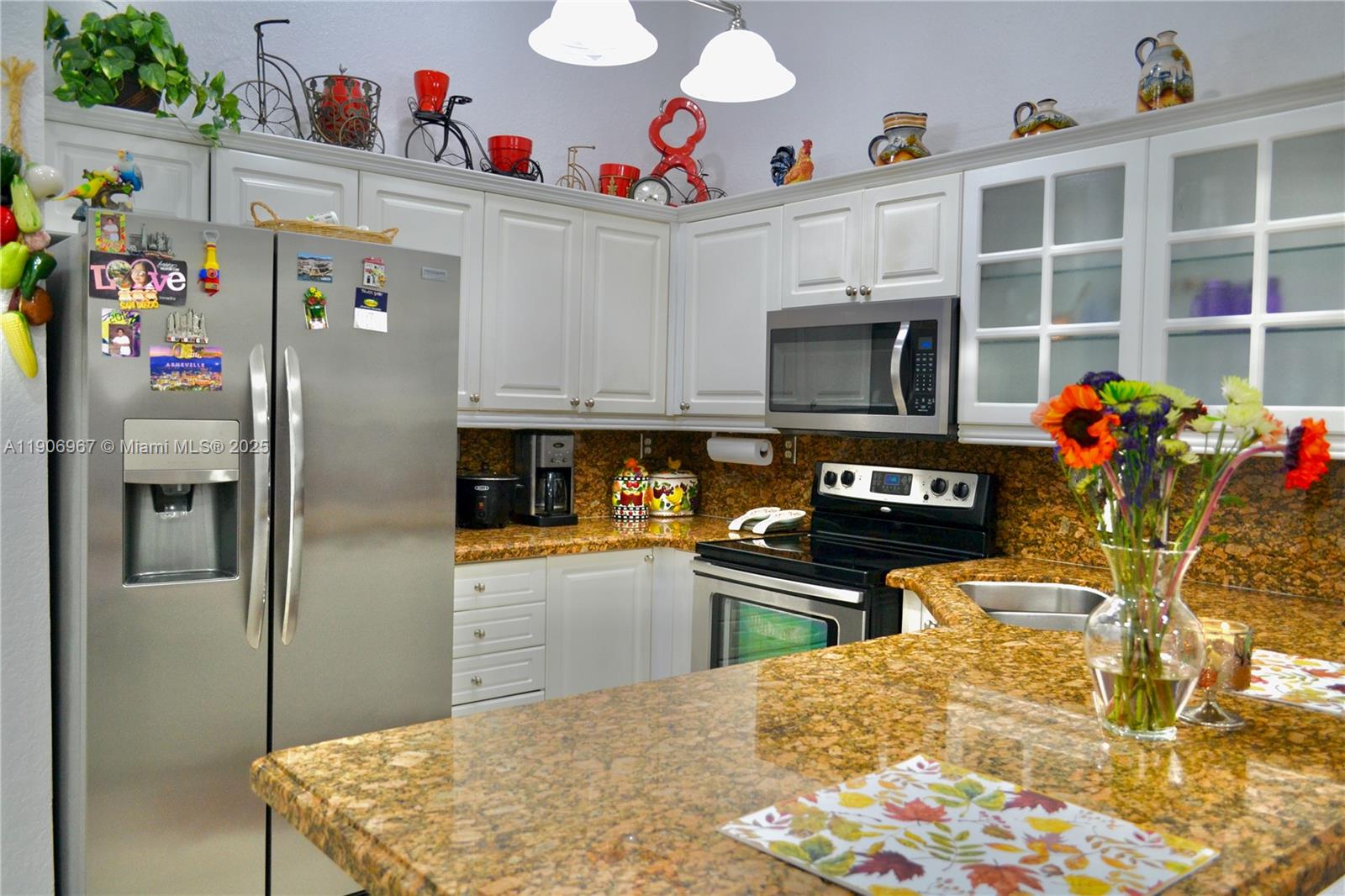 13778 Southwest 170th Lane Miami, FL 33177 - Photo 9 of 23 a kitchen with granite countertop a refrigerator and a stove top oven