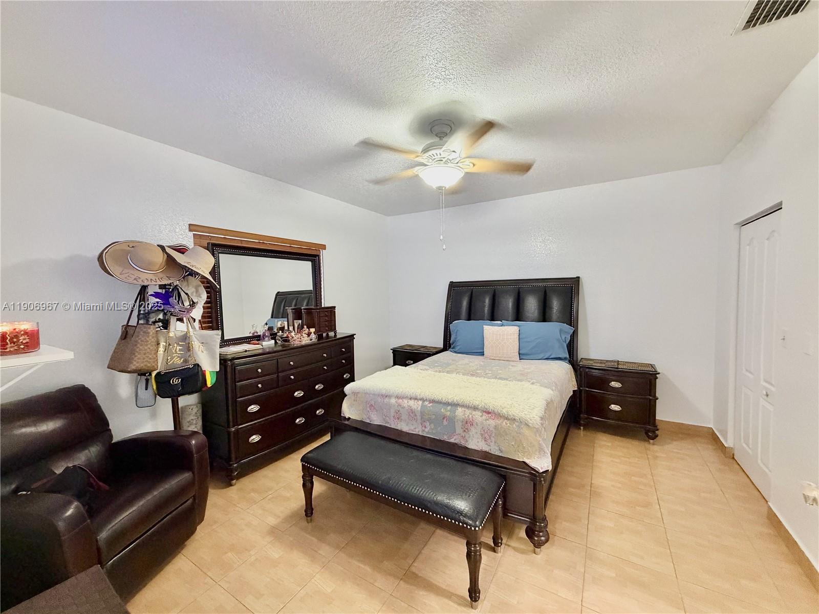 13778 Southwest 170th Lane Miami, FL 33177 - Photo 10 of 23 a bedroom with a bed and a chandelier