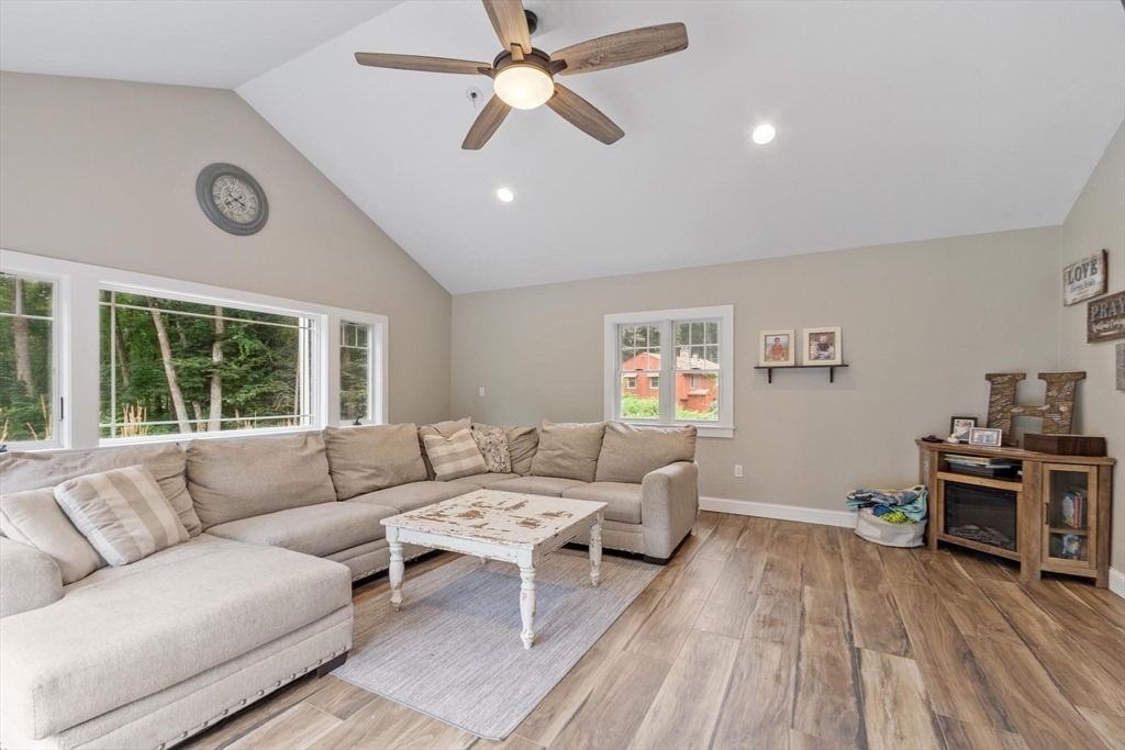 241 Reservoir Road Lunenburg, MA 01462 - Photo 19 of 40 a living room with furniture and a large window
