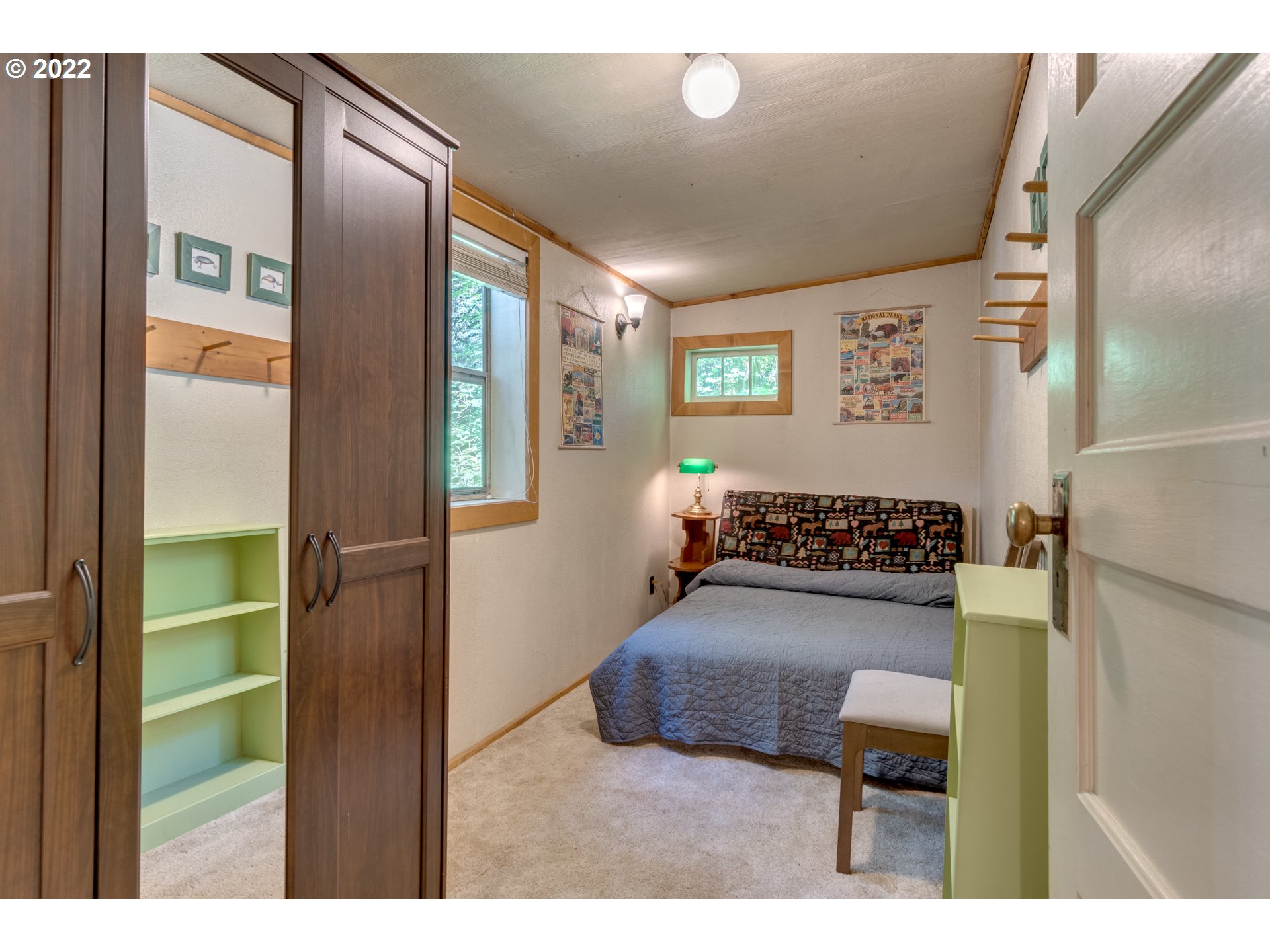 29018 Road 20, Unit LOT67 Rhododendron, OR 97049 - Photo 19 of 31 a bedroom with furniture and a book