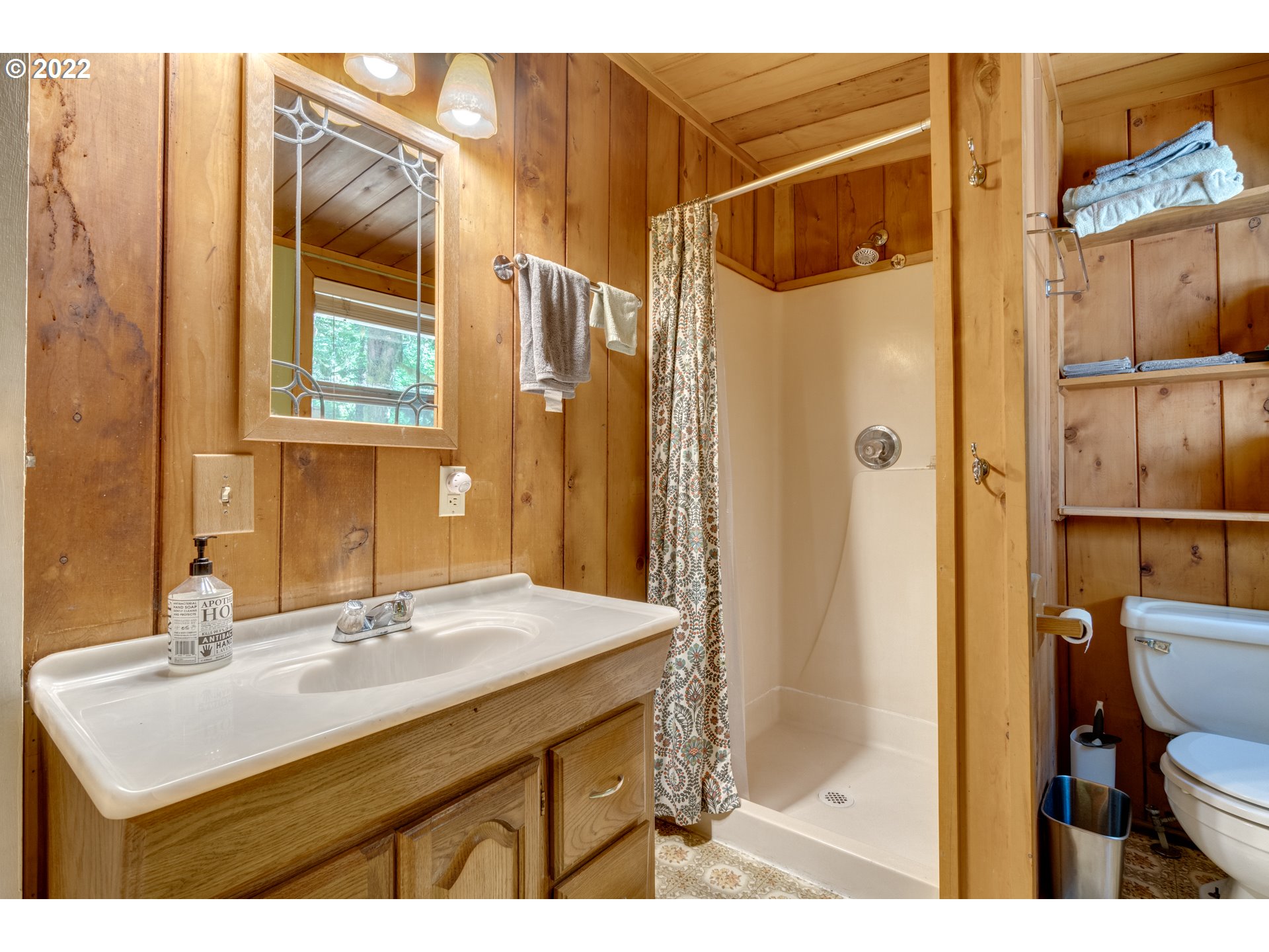 29018 Road 20, Unit LOT67 Rhododendron, OR 97049 - Photo 22 of 31 a bathroom with a sink mirror and a shower