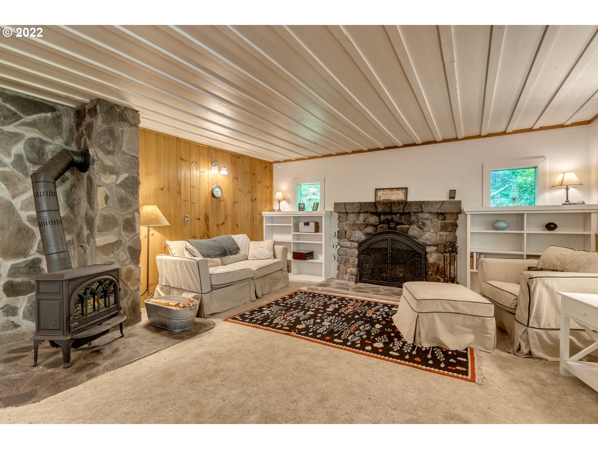 29018 Road 20, Unit LOT67 Rhododendron, OR 97049 - Photo 8 of 31 a living room with furniture a fireplace a rug and a table