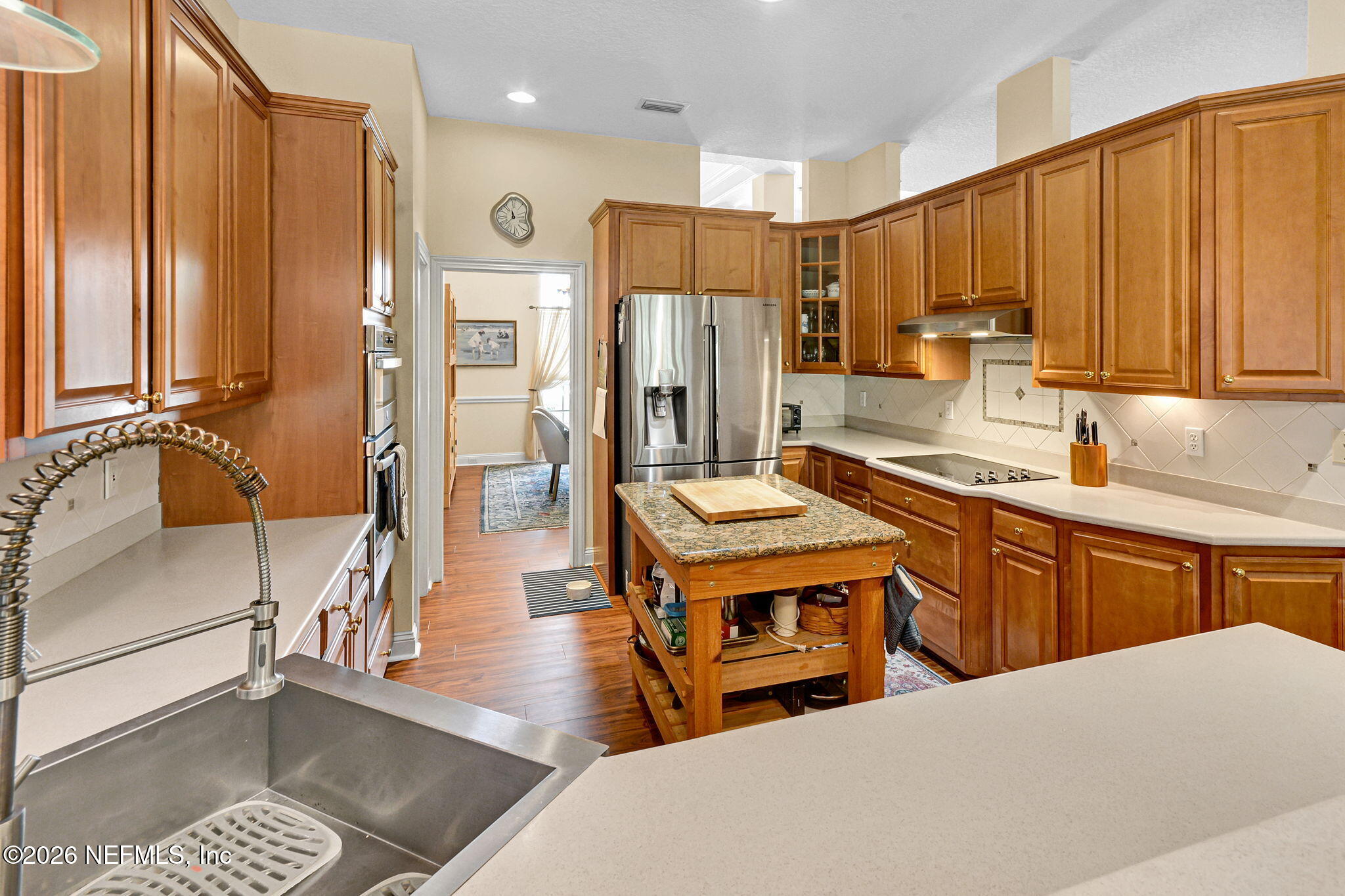 5950 West Shores Road Orange Park, FL 32003 - Photo 16 of 42 a open kitchen with stainless steel appliances granite countertop a stove a sink dishwasher and a refrigerator with wooden floor