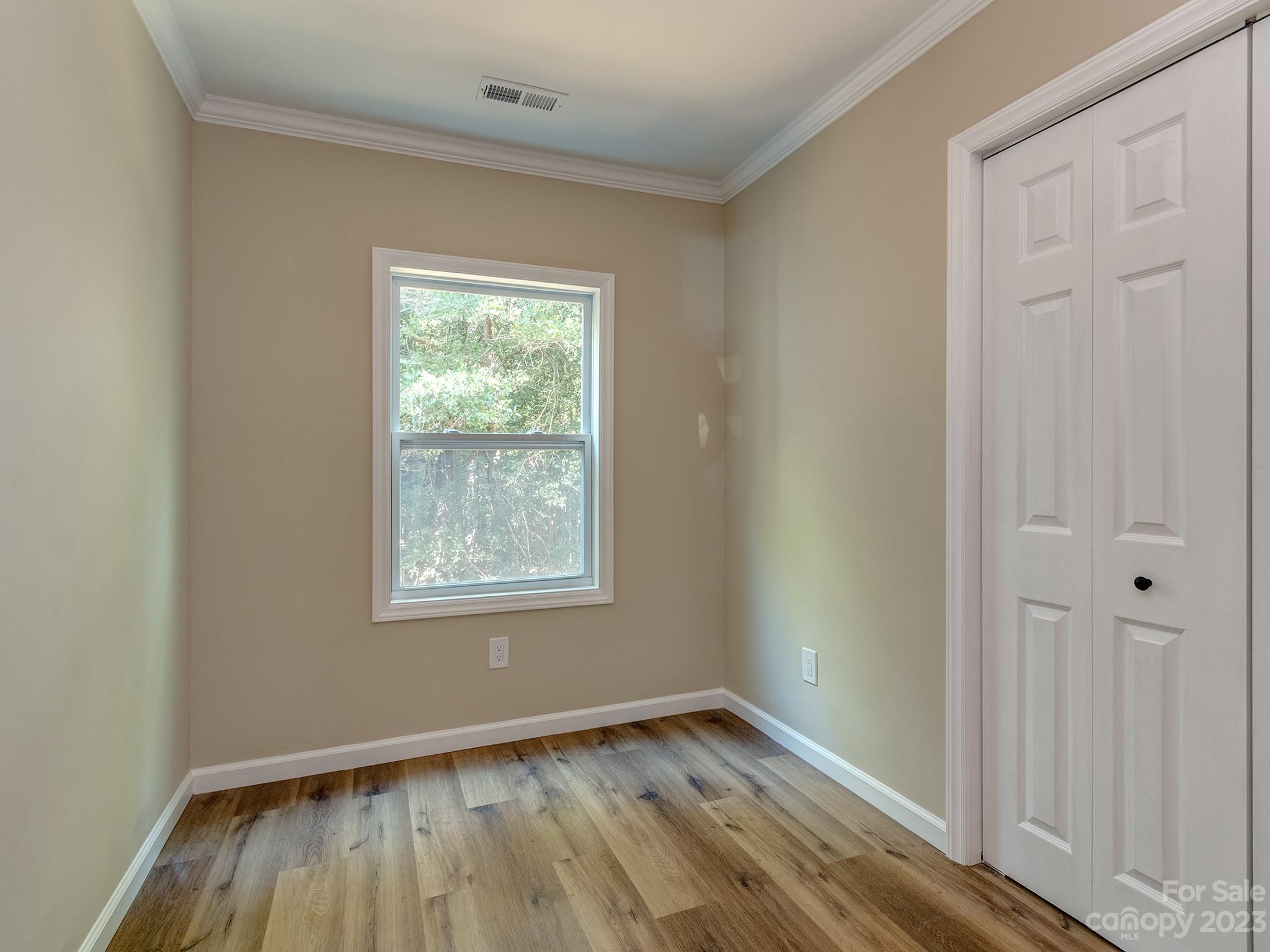1031 State Rd S-29-424 Lancaster, SC 29720 - Photo 17 of 47 an empty room with wooden floor and windows