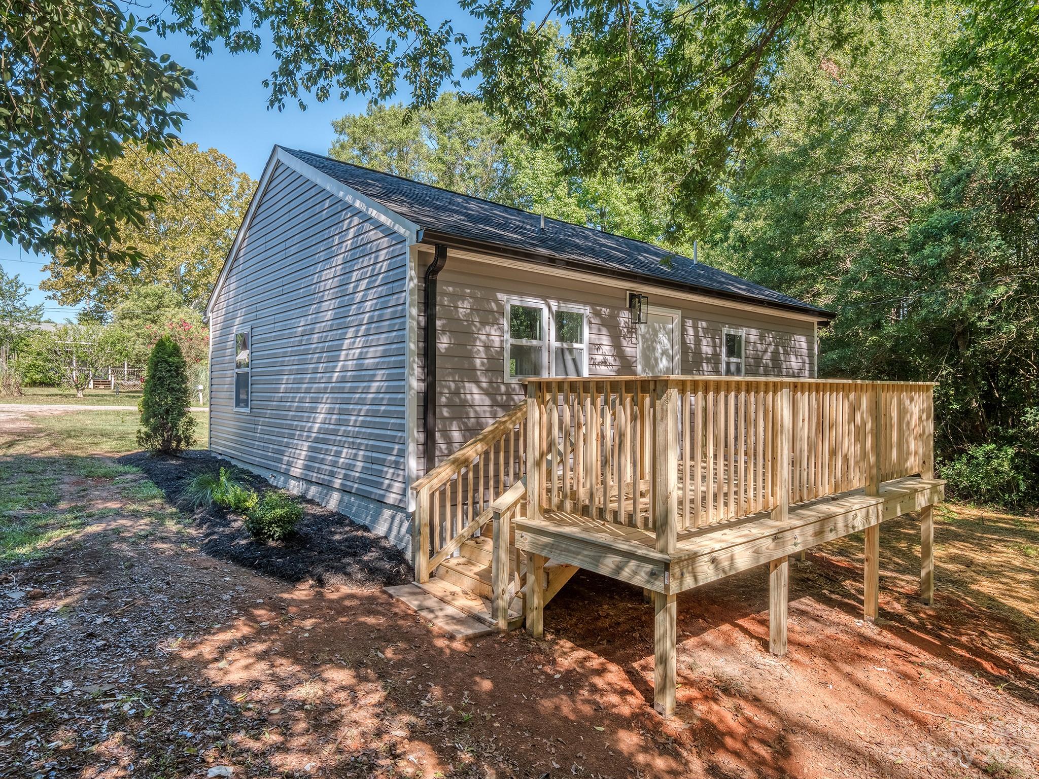 1031 State Rd S-29-424 Lancaster, SC 29720 - Photo 21 of 47 a view of a small house with a wooden deck and furniture